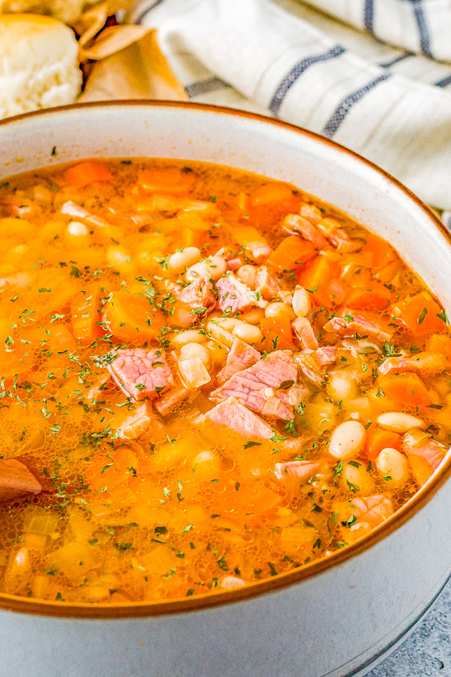 Slow Cooker Ham and Bean Soup - An incredibly EASY and comforting soup that can be made with leftover holiday ham or deli ham! Your slow cooker does all the work to meld the flavors together. OR you can also make this on the stove top in 30 minutes!