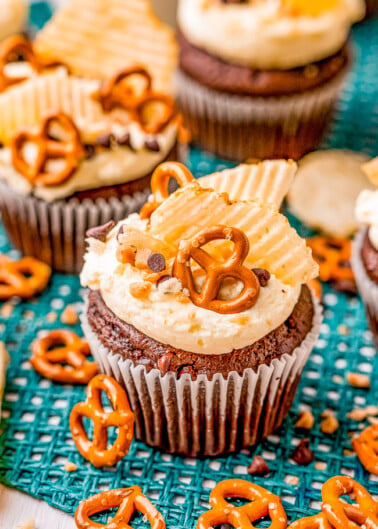 Kitchen Sink Cupcakes – Rich and decadent chocolate cupcakes topped with everything but the kitchen sink including pretzels, potato chips, toffee bits, and chocolate chips! FAST and EASY cupcakes to make because they use a chocolate cake mix base to save you time!