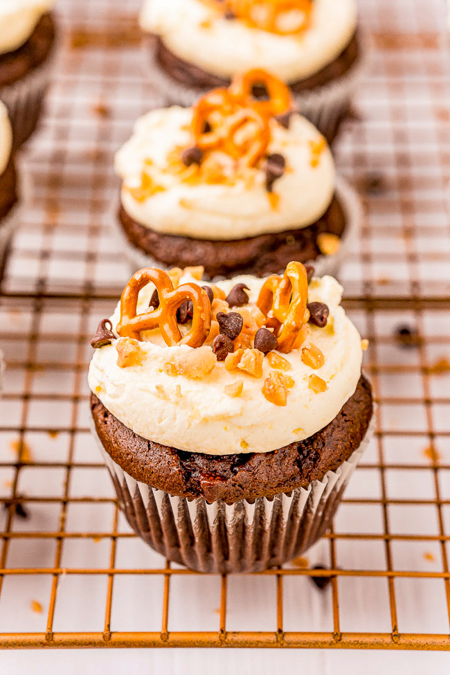 Kitchen Sink Cupcakes - Rich and decadent chocolate cupcakes topped with everything but the kitchen sink including pretzels, potato chips, toffee bits, and chocolate chips! FAST and EASY cupcakes to make because they use a chocolate cake mix base to save you time!