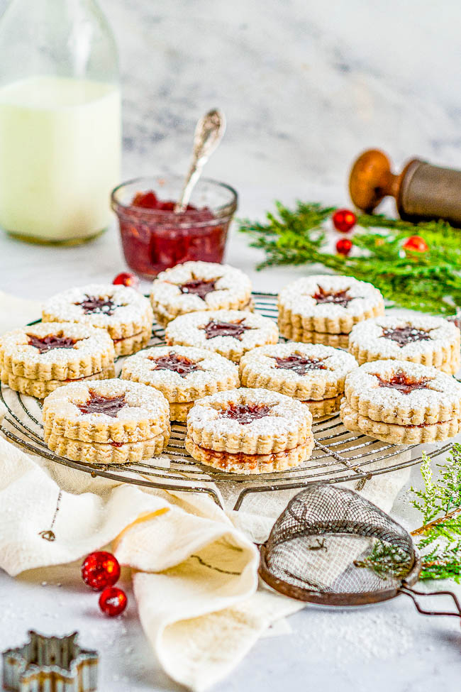 Raspberry Linzer Cookies — Linzer cookies are the ultimate sandwich cookies! A layer of raspberry jam is tucked in between two buttery, nutty cookies and dusted with powdered sugar! Great Christmas cookies that are perfect to serve at your holiday parties or to include in cookie exchanges!