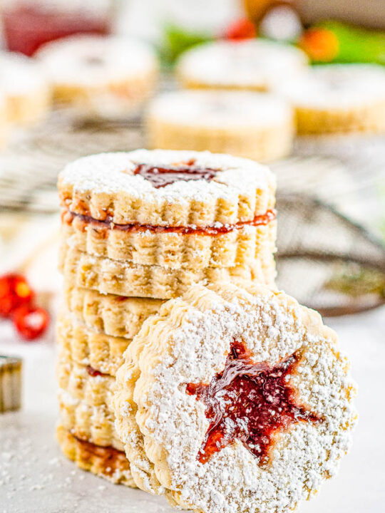 Snowflake Linzer Cookies - Linzer cookies are the ultimate sandwich cookies! A layer of raspberry jam is tucked in between two buttery, nutty cookies and dusted with powdered sugar! Great Christmas cookies that are perfect to serve at your holiday parties or to include in cookie exchanges!