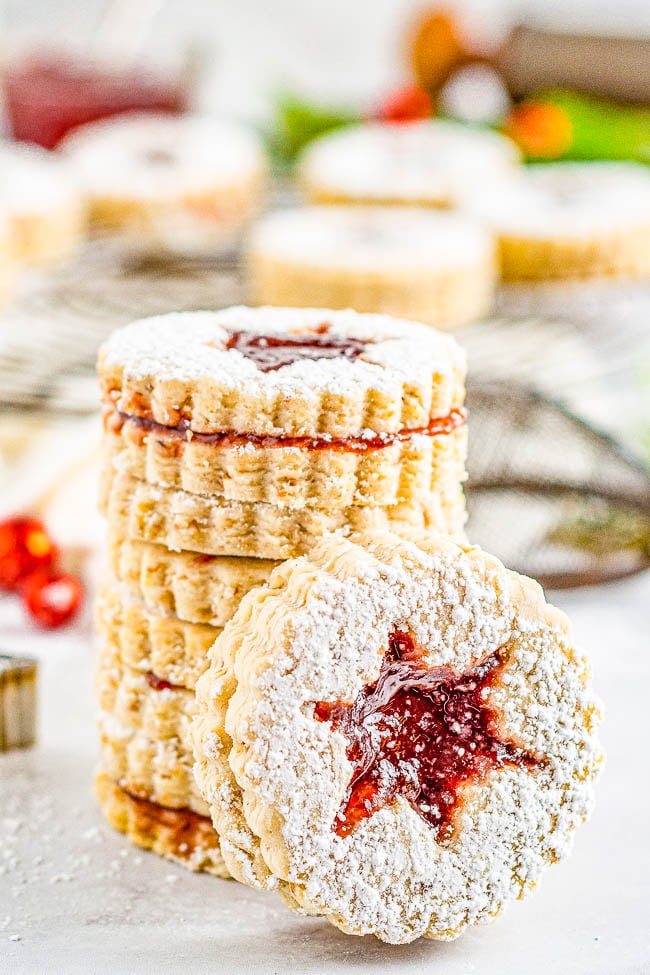 Raspberry Linzer Cookies — Linzer cookies are the ultimate sandwich cookies! A layer of raspberry jam is tucked in between two buttery, nutty cookies and dusted with powdered sugar! Great Christmas cookies that are perfect to serve at your holiday parties or to include in cookie exchanges!