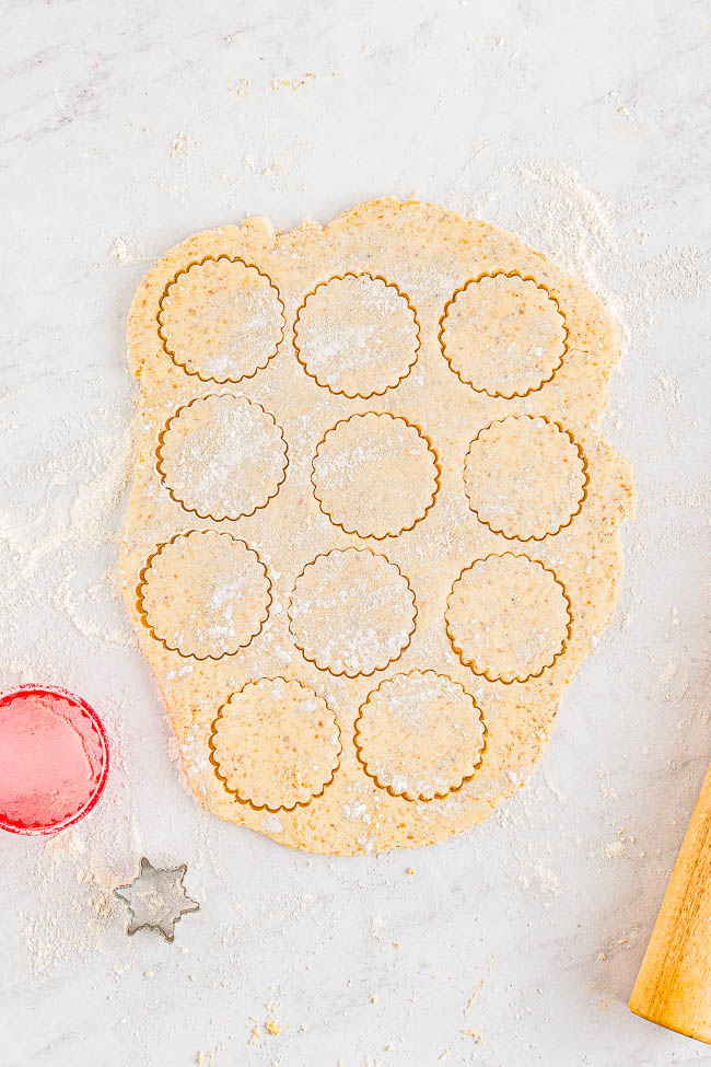 Snowflake Linzer Cookies - Linzer cookies are the ultimate sandwich cookies! A layer of raspberry jam is tucked in between two buttery, nutty cookies and dusted with powdered sugar! Great Christmas cookies that are perfect to serve at your holiday parties or to include in cookie exchanges!
