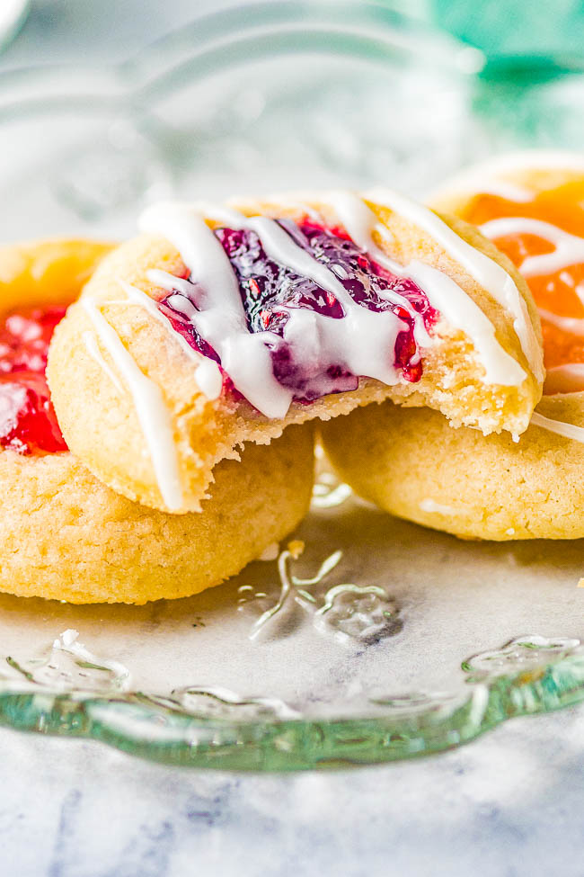 Classic JamThumbprint Cookies — These easy thumbprint cookies are tender, buttery, and the 3 different types of jam turns into chewy little jewels that make these nostalgic family favorite cookies! Great for holiday entertaining, cookie exchanges, showers, or just because! No one can resist the allure of these classic thumbprint cookies!