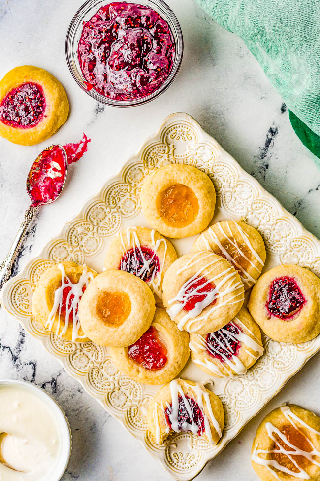 Thumbprint Cookies – These easy thumbprint cookies are tender, buttery, and the 3 different types of jelly turns into chewy little jewels that make these nostalgic family favorite cookies! Great for holiday entertaining, cookie exchanges, showers, or just because! No one can resist the allure of these classic thumbprint cookies!
