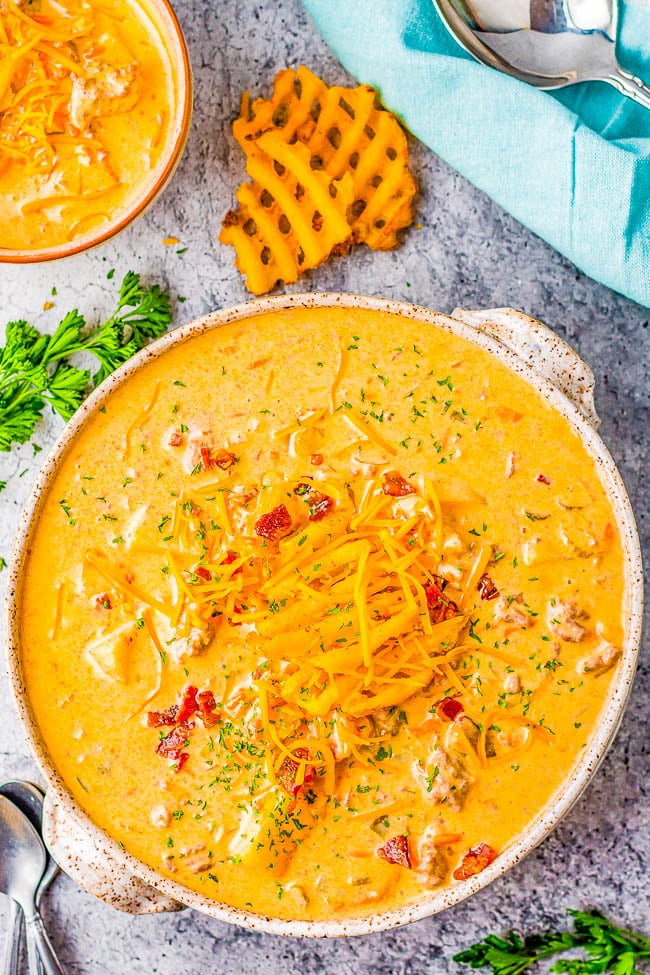 Slow Cooker Cheeseburger Soup - A decadent dish that's like eating a loaded cheeseburger, but in soup form! Ground beef, bacon, cheese, and an array of vegetables give fantastic depth of flavor. SO EASY because your slow cooker does ALL the work! A guaranteed family favorite especially when it's chilly.
