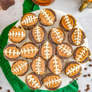 Chocolate Football Cupcakes - Decadent chocolate cupcakes, filled with smooth rich chocolate ganache, and topped with creamy chocolate buttercream frosting for a trifecta of chocolate! The cupcakes will be game day winners with all your hungry fans!