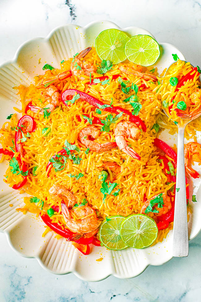 Instant Pot Shrimp Paella - All the rich flavors of classic Spanish paella but made in your Instant Pot and ready in 25 minutes! Plump and juicy shrimp, crisp-tender bell peppers and peas, all tossed in saffron and paprika seasoned rice! An EASY recipe that's perfect for busy weeknights!