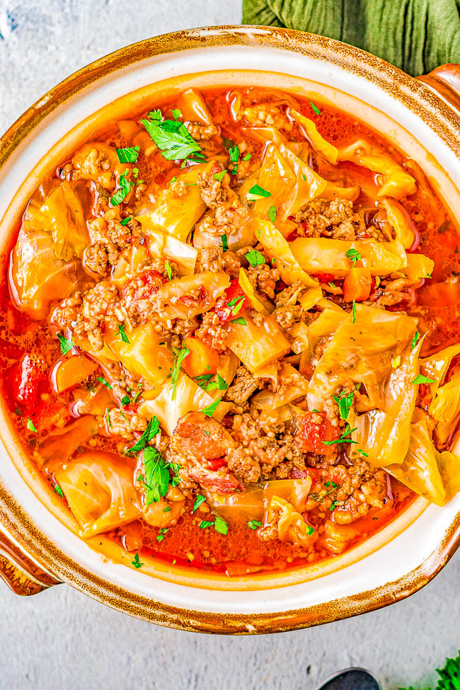 Slow Cooker Cabbage Roll Soup - A hearty comfort food soup recipe the whole family will love. If you think that soup can't be a meal, guess again! This slow cooker soup is chock full of bacon, ground beef, green cabbage, rice, carrots, fire roasted tomatoes, and more! Perfect for chilly weather, busy weeknights, and the leftovers freeze great! 