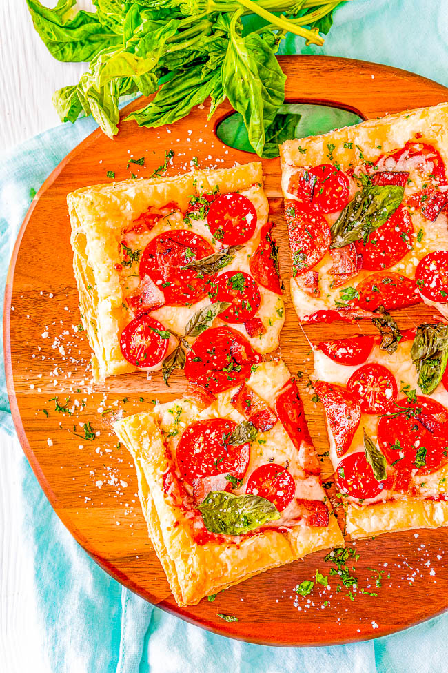 Puff Pastry Pizza - This EASY pizza is topped with oodles of cheese, pepperoni, bacon, cherry tomatoes, fresh basil, and has a puff pastry crust! Never underestimate the power of a kitchen shortcut like puff pastry on busy weeknights when you're looking for a family-friendly and kid-approved dinner recipe that's FAST to make! 
