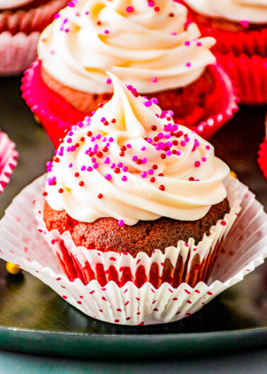 Chocolate Truffle Red Velvet Cupcakes – Tender fluffy red velvet cupcakes stuffed with chocolate truffles and topped with sweet and tangy cream cheese frosting! EASY to make and the PERFECT Valentine’s Day or holiday treat sure to impress your family and friends!