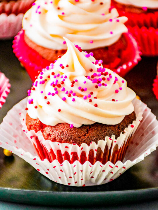 Chocolate Truffle Red Velvet Cupcakes – Tender fluffy red velvet cupcakes stuffed with chocolate truffles and topped with sweet and tangy cream cheese frosting! EASY to make and the PERFECT Valentine’s Day or holiday treat sure to impress your family and friends!