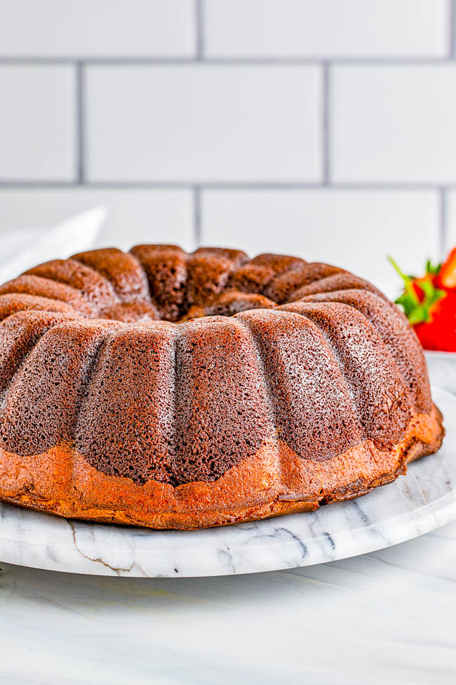 Triple Chocolate Bundt Cake - A rich, dense, and decadent chocolate cake that's filled with an airier chocolate cheesecake and topped with smooth chocolate ganache is a chocoholics DREAM! A celebration cake that's perfect for Valentine's Day, Christmas parties, or special anniversaries and birthdays that's sure to receive RAVE REVIEWS!