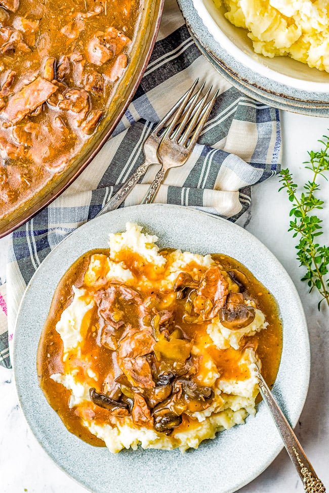 Instant Pot Beef Tips - Tender juicy beef tips smothered in loads of savory mushroom gravy! So much hearty flavor and just PERFECT for piling over mashed potatoes or noodles! An EASY family-favorite comfort food recipe made entirely in your Instant Pot in about 30 minutes! 