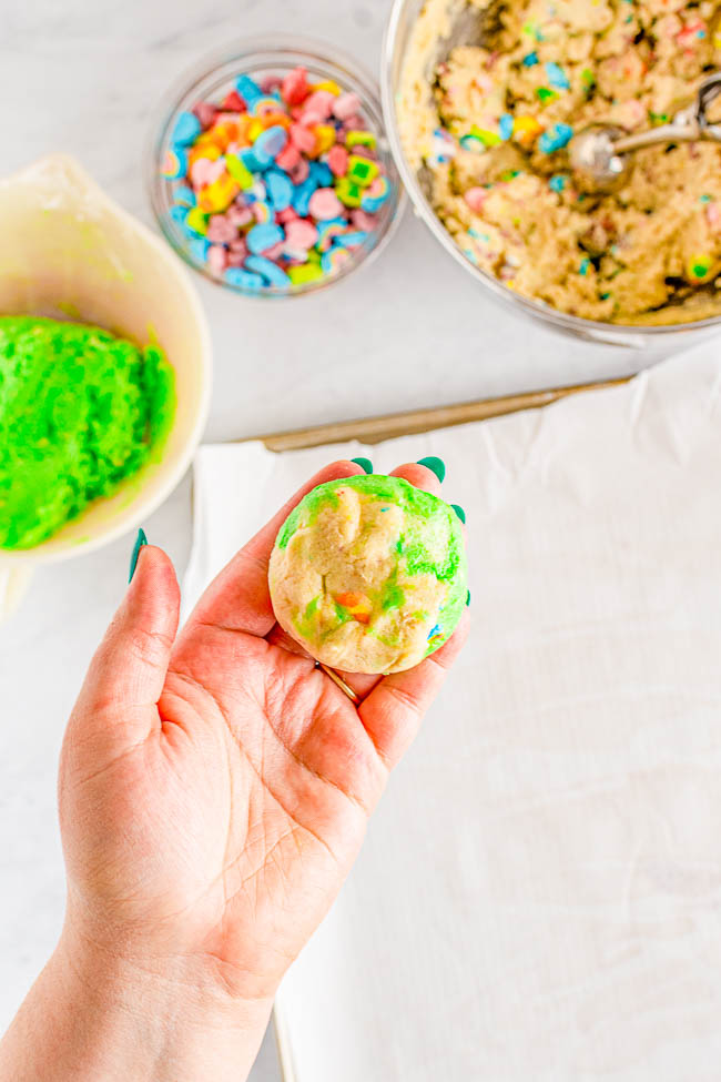 Lucky Charms Cookies - Soft and ULTRA CHEWY sugar cookies made with Lucky Charms cereal in the dough plus plenty of marshmallows! Every Leprechaun you know is going to love this fun Saint Patrick's Day dessert! Directions provided to make either plain OR extra festive green-marbled cookies.