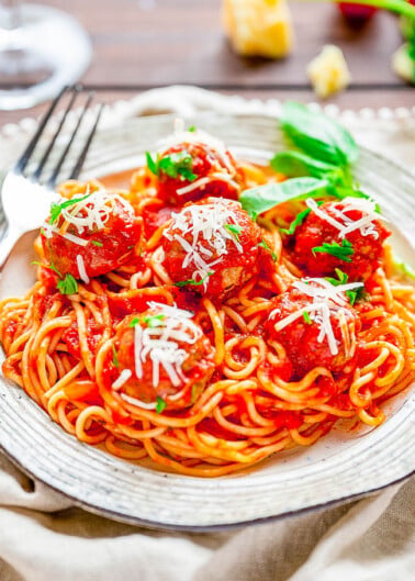 Spaghetti and Meatballs - A family favorite recipe that never goes out of style! Made with homemade beef and pork baked meatballs, homemade marinara sauce, and perfectly cooked al dente spaghetti, this Italian classic is sure to get rave reviews! Not only do they taste FABULOUS but both homemade meatballs and homemade marinara are FASTER and EASIER than you may think!ย
