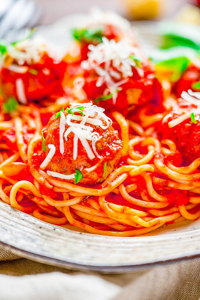 Spaghetti and Meatballs - A family favorite recipe that never goes out of style! Made with homemade beef and pork baked meatballs, homemade marinara sauce, and perfectly cooked al dente spaghetti, this Italian classic is sure to get rave reviews! Not only do they taste FABULOUS but both homemade meatballs and homemade marinara are FASTER and EASIER than you may think! 