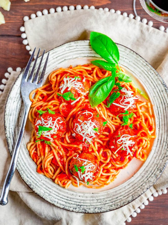 Spaghetti and Meatballs - A family favorite recipe that never goes out of style! Made with homemade beef and pork baked meatballs, homemade marinara sauce, and perfectly cooked al dente spaghetti, this Italian classic is sure to get rave reviews! Not only do they taste FABULOUS but both homemade meatballs and homemade marinara are FASTER and EASIER than you may think! 