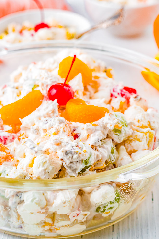 Ambrosia Salad - This classic fruit salad is made with pineapple, mandarin oranges, grapes, coconut, and tossed in a light and creamy, tangy-yet-sweet dressing! The EASIEST side dish ever - just add everything to one bowl and stir! A family favorite side dish that's always PERFECT for holidays, events, and parties! 
