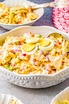 Amish Pasta Salad - A family-favorite classic pasta salad recipe with al dente pasta, bell peppers, celery, red onions, and hard-boiled eggs tossed in a creamy tangy-sweet dressing! Perfect for picnics, potlucks, backyard parties, and events! Everyone will go back for a second helping of this comforting side salad! 