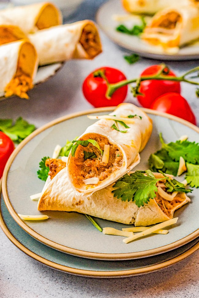 Baked Cheesy Beef Taquitos - Craving Mexican food? Make these EASY taquitos made with seasoned ground beef, melted cheese, cream cheese, sour cream, salsa, and baked to crispy perfection! Family friendly, picky-eater approved, and PERFECT for busy weeknight dinners, game day events or parties! 