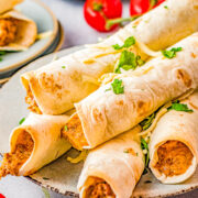Baked Cheesy Beef Taquitos - Craving Mexican food? Make these EASY taquitos made with seasoned ground beef, melted cheese, cream cheese, sour cream, salsa, and baked to crispy perfection! Family friendly, picky-eater approved, and PERFECT for busy weeknight dinners, game day events or parties! 