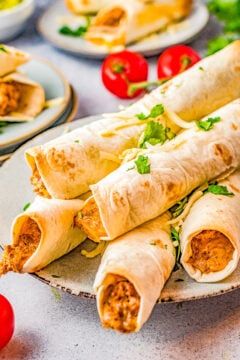 Baked Cheesy Beef Taquitos - Craving Mexican food? Make these EASY taquitos made with seasoned ground beef, melted cheese, cream cheese, sour cream, salsa, and baked to crispy perfection! Family friendly, picky-eater approved, and PERFECT for busy weeknight dinners, game day events or parties!ย