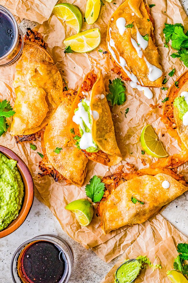 Cauliflower Tinga Tacos with Avocado Crema - Roasted cauliflower is drenched in a smoky, perfectly spicy chipotle sauce, then folded into corn tortillas, cheese is added, and baked to crispy perfection! A bright avocado crema sauce is the finishing touch! Naturally gluten-free vegetarian food never tasted so AMAZING! You'll never miss the meat in these healthy tacos!