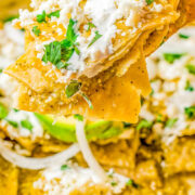 Chilaquiles Verdes being lifted from a skillet.