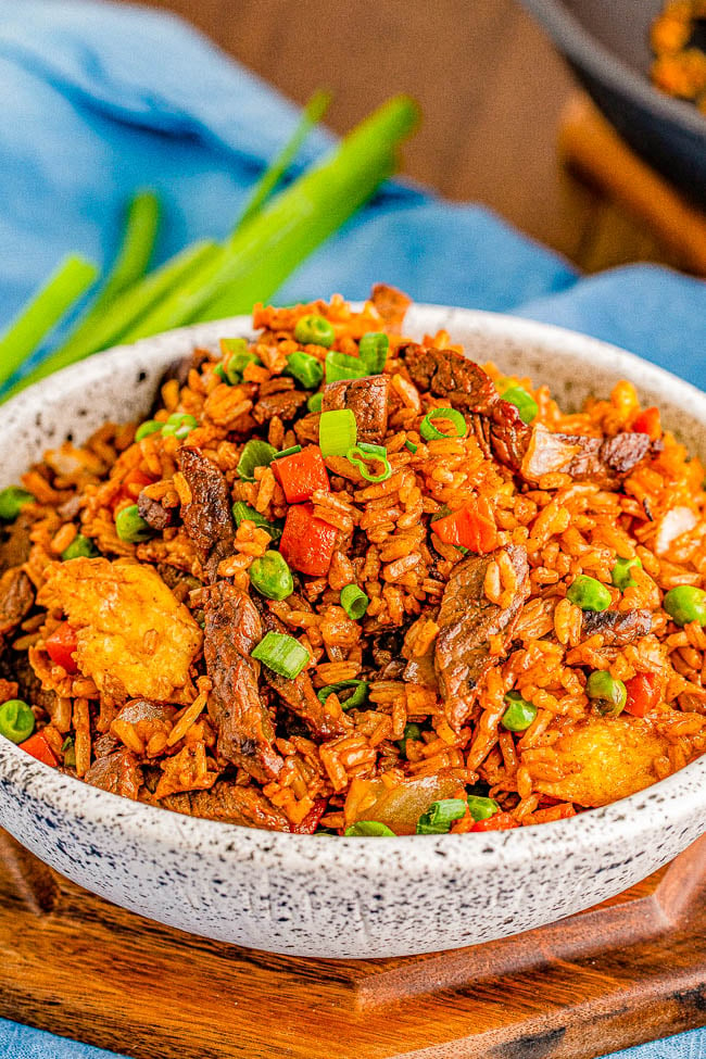 Beef Fried Rice - This better-than-takeout beef fried rice is EASY, ready in 20 MINUTES, and made in ONE skillet! Everyone loves the big juicy strips of steak and perfectly fried rice that's speckled with bits of onions, peas, carrots, and scrambled eggs. The combination of the soy sauces, oyster sauce, and toasted sesame oil make it taste so authentic! 