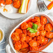 Slow Cooker Buffalo Chicken Meatballs - EASY homemade chicken meatballs that simmer in buffalo wing sauce, seasonings, and spices in your slow cooker! Juicy and full of all the flavor of traditional buffalo chicken wings, minus the messy factor! Great for game day parties, holidays, graduations, or anytime you need an appetizer that kids and adults alike just adore! 