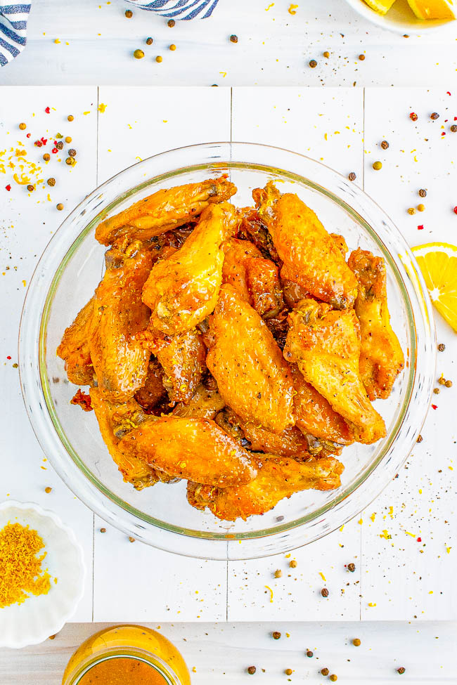 Baked Lemon Pepper Wings - It doesn't get any better than chicken wings with crispy skin and juicy fall-off-the-bone meat! The baked chicken wings are tossed in a delectable, buttery, lemon pepper sauce that clings to the wings perfectly! Serve them for summer holidays, backyard get-togethers, game day parties, or any wing-worthy moment! Air fryer instructions also provided.