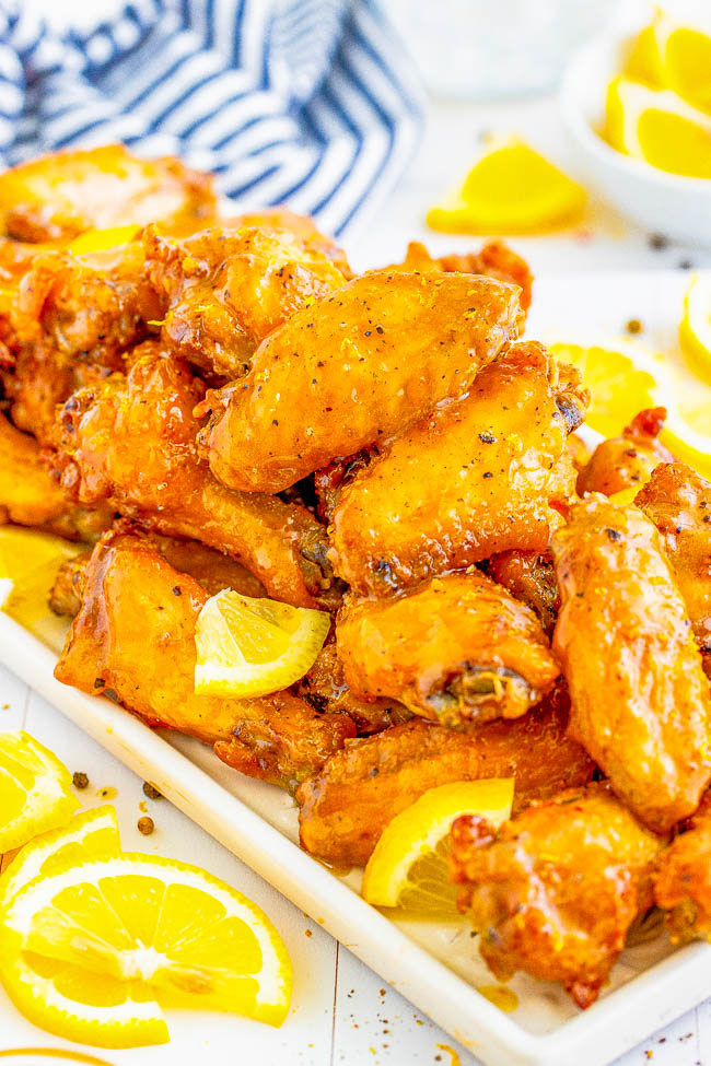 Baked Lemon Pepper Wings - It doesn't get any better than chicken wings with crispy skin and juicy fall-off-the-bone meat! The baked chicken wings are tossed in a delectable, buttery, lemon pepper sauce that clings to the wings perfectly! Serve them for summer holidays, backyard get-togethers, game day parties, or any wing-worthy moment! Air fryer instructions also provided.