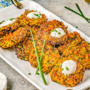 Air Fryer Zucchini Fritters - Lightly crisped on the outside, tender on the inside, and makes use of summer's most abundant vegetable! And air frying the zucchini fritters keeps them healthier than actual frying without sacrificing taste or texture! Perfect as an appetizer, side dish, or healthy main course. Oven baking instructions also provided.