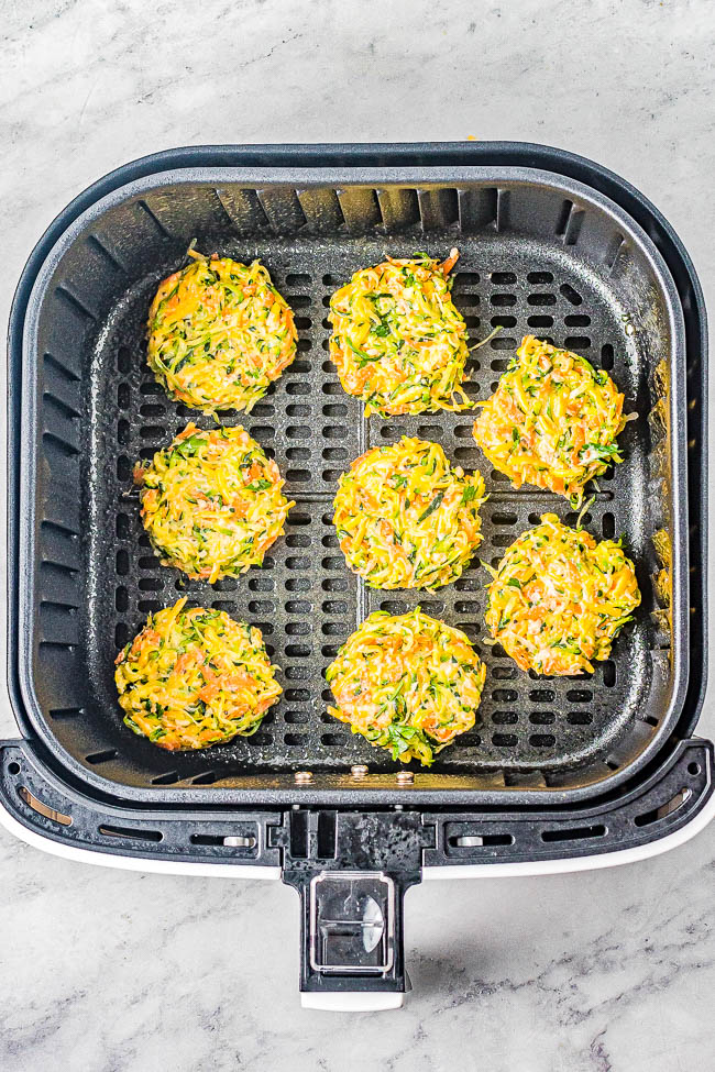 Air Fryer Zucchini Fritters - Lightly crisped on the outside, tender on the inside, and makes use of summer's most abundant vegetable! And air frying the zucchini fritters keeps them healthier than actual frying without sacrificing taste or texture! Perfect as an appetizer, side dish, or healthy main course. Oven baking instructions also provided.