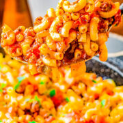 American Goulash - Hearty, easy, comfort food made with ground beef and sausage, tender elbow macaroni, green peppers, onions, and tomatoes. The mixture simmers in marinara sauce for layers of flavor! Ready in just 30 minutes and makes a big batch that's perfect for potlucks, picnics, game days, or to have planned leftovers on hand. This classic American goulash recipe is always a family favorite! 