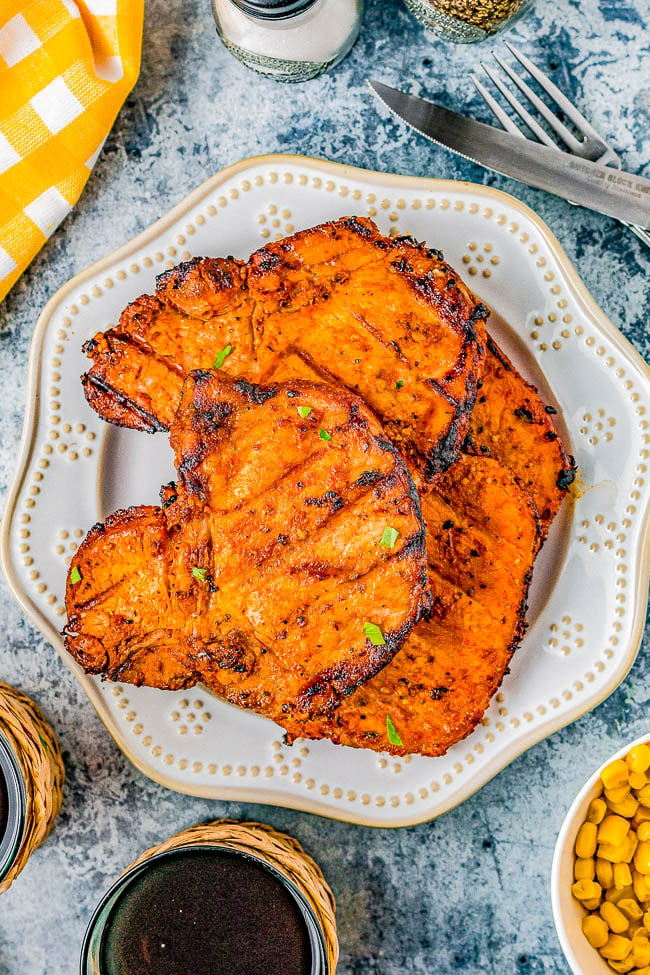 Grilled Pork Chops - Learn how to make juicy and tender pork chops on the grill thanks to a super simple homemade marinade that provides the perfect amount of savory flavor! When combined with the natural smoky flavor you get from the grill, these marinated grilled pork chops are a FAST and EASY family favorite! Indoor cooking instructions also provided.