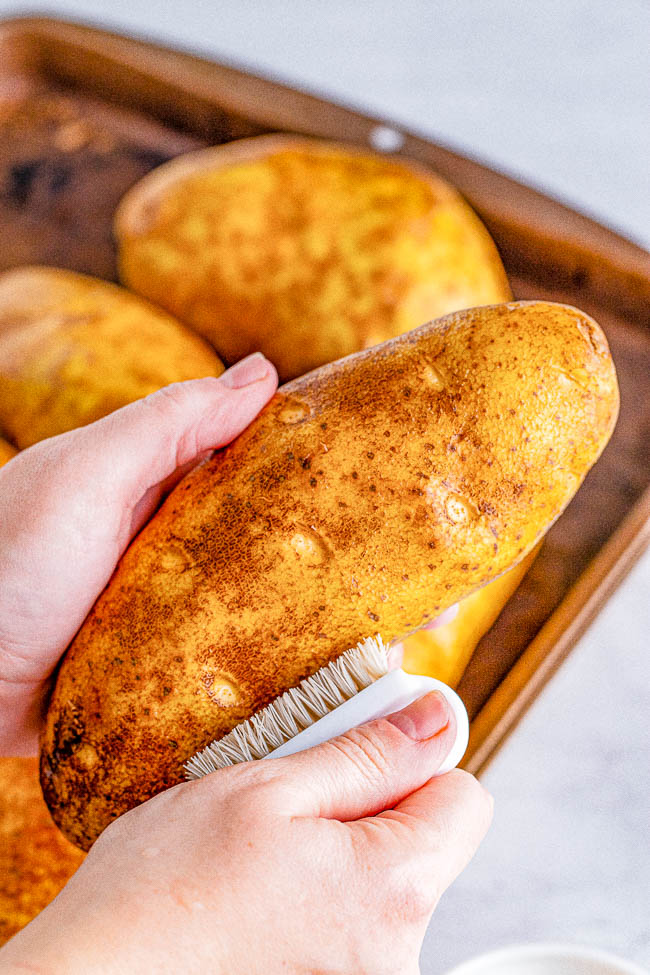 Slow Cooker Baked Potatoes - Learn how to make soft, fluffy, tender potatoes with super delicious skin in your slow cooker! Use this method when you want to free up oven space for a holiday meal or when you don't want to turn your oven on and heat up your house. Foolproof, perfect potatoes every time! 
