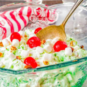 Watergate Salad - The classic side salad that's light, sweet, fluffy, and creamy! Made with just 6 ingredients including pineapple, pistachio pudding mix, marshmallows, maraschino cherries, pecans, and whipped topping! A one-bowl, stir-together, 5-minute recipe that's perfect for casual events, parties, and family dinners. Everyone loves this one!