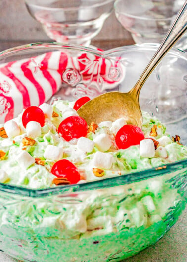 Watergate Salad - The classic side salad that's light, sweet, fluffy, and creamy! Made with just 6 ingredients including pineapple, pistachio pudding mix, marshmallows, maraschino cherries, pecans, and whipped topping! A one-bowl, stir-together, 5-minute recipe that's perfect for casual events, parties, and family dinners. Everyone loves this one!