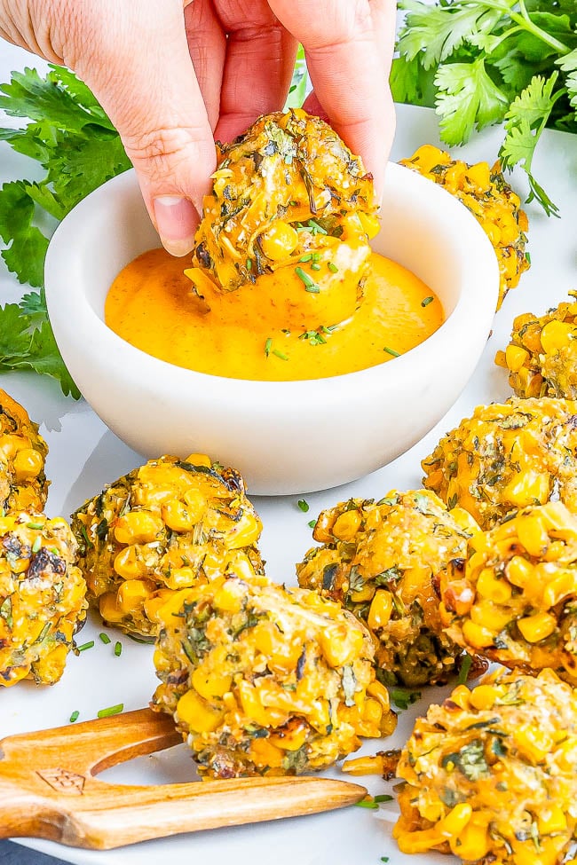 Baked Zucchini Corn Poppers - Celebrating the flavors of summer in these EASY poppers that are slightly crispy on the outside and soft on the inside! Layered with flavor thanks to not only zucchini and corn, but also shredded cheese, fresh herbs and spices, and serrano chili for a kick making you want to pop just one more! Air fryer instructions as well as vegan and gluten-free options provided. 