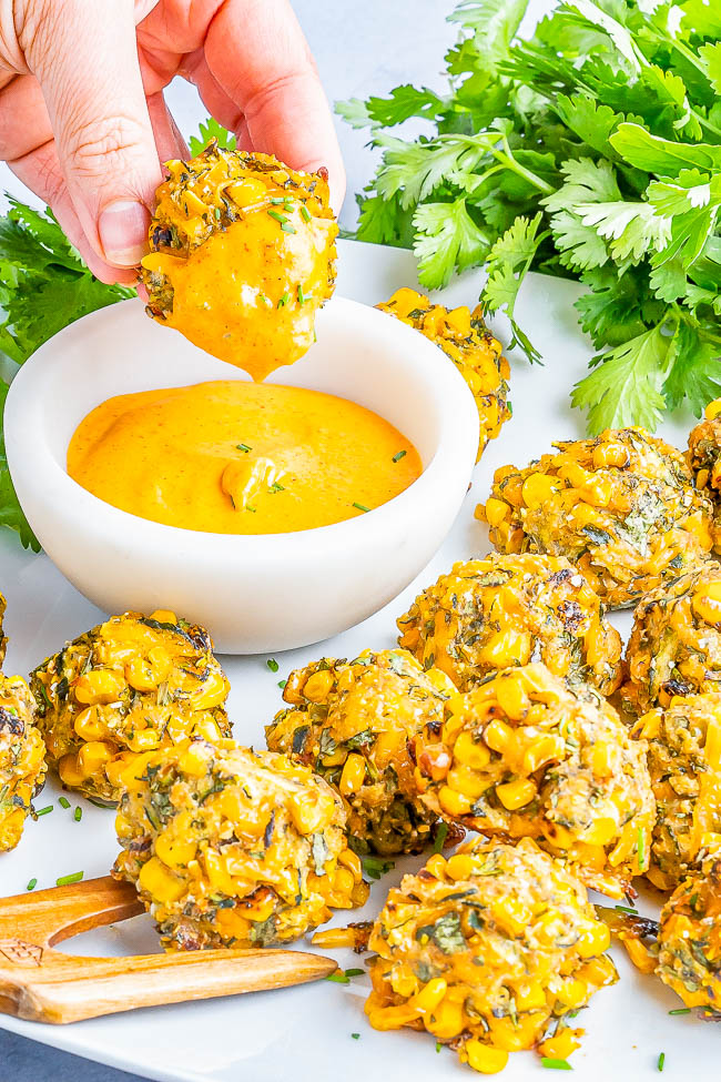 Baked Zucchini Corn Fritters — Celebrating the flavors of summer in these EASY poppers that are slightly crispy on the outside and soft on the inside! Layered with flavor thanks to not only zucchini and corn, but also shredded cheese, fresh herbs and spices, and serrano chili for a kick making you want to pop just one more! Air fryer instructions as well as vegan and gluten-free options provided. 