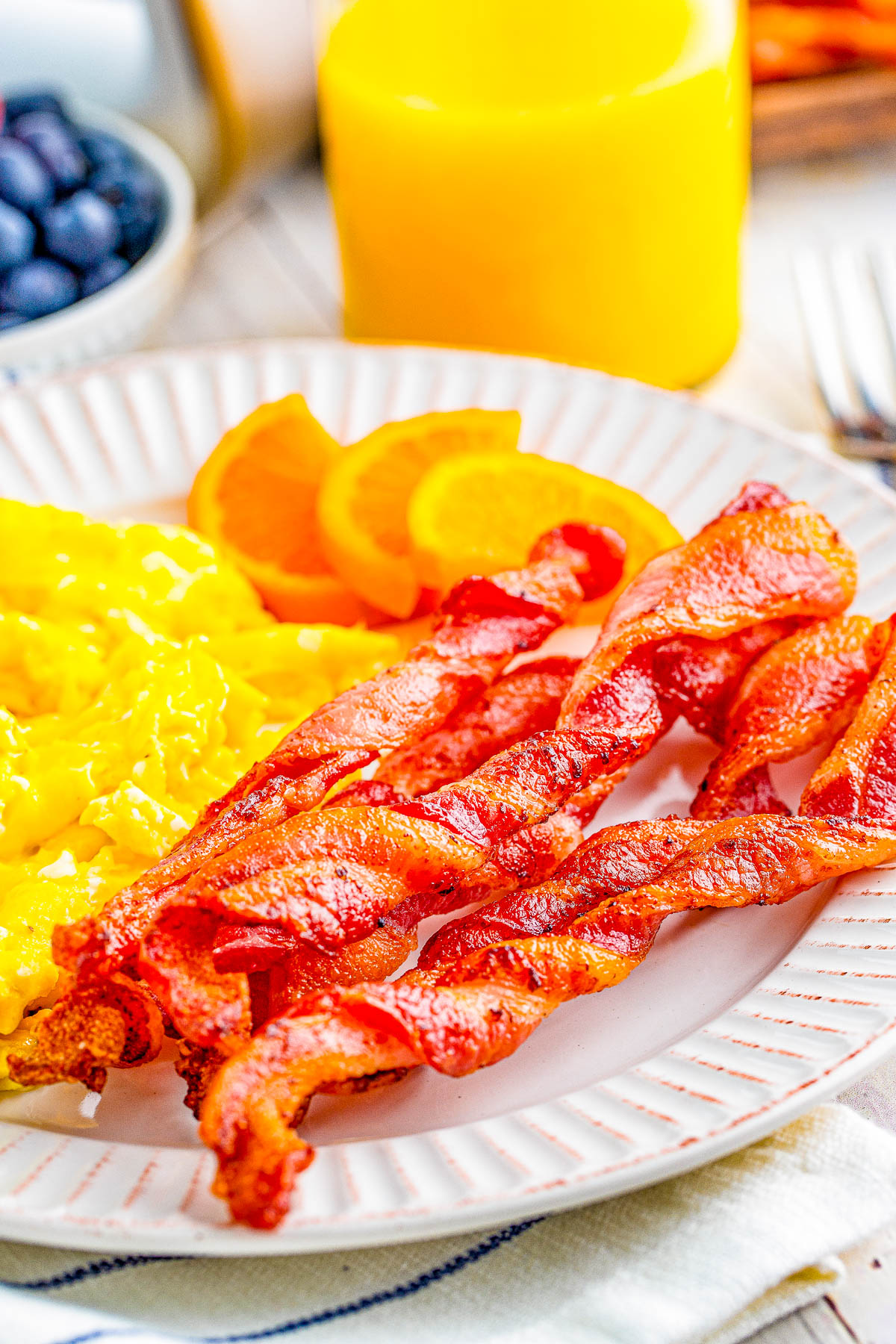 Air Fryer Twisted Bacon - Every bite of this twisted bacon is lightly crisped on the outside while being tender, juicy, and delicious on the inside! Learn how to make this TikTok trend-inspired bacon in your air fryer. FAST, EASY, and so crave-worthy! Oven baking instructions also provided.