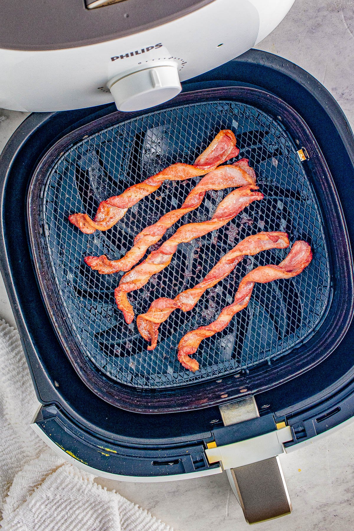 Air Fryer Twisted Bacon - Every bite of this twisted bacon is lightly crisped on the outside while being tender, juicy, and delicious on the inside! Learn how to make this TikTok trend-inspired bacon in your air fryer. FAST, EASY, and so crave-worthy! Oven baking instructions also provided.