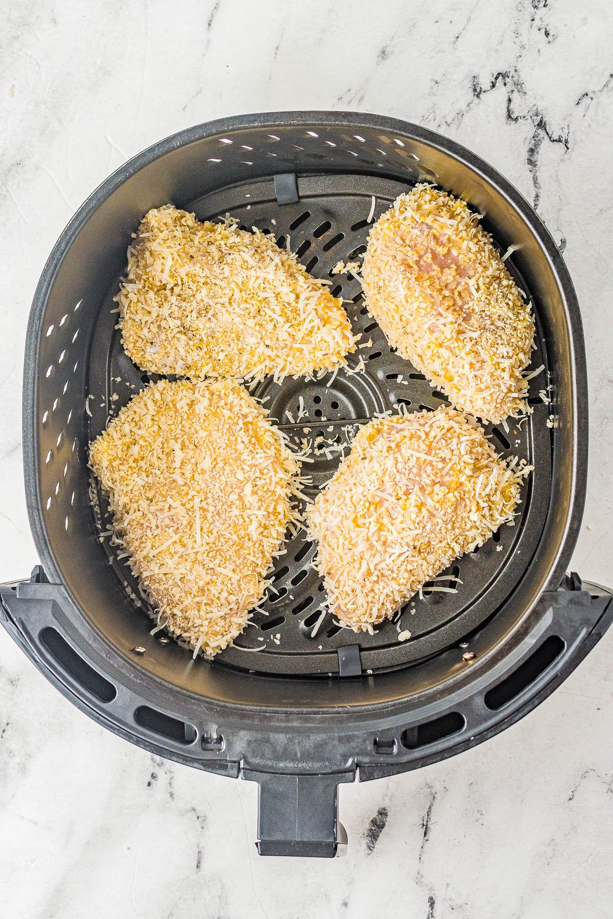 Air Fryer Parmesan Chicken - Coated in a mixture of panko bread crumbs and Parmesan cheese, this "fried" chicken is perfectly crispy on the outside and juicy, tender, and moist inside! It's EASY, ready in 15 minutes, perfect for busy weeknights, and a healthier way to indulge in fried chicken! Oven-baking instructions also provided.