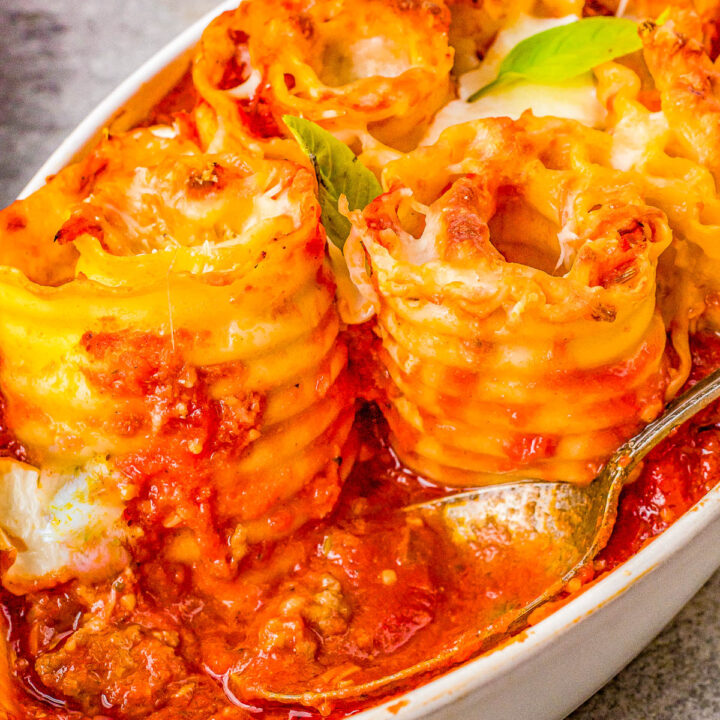 Lasagna Pinwheels - Rolled up lasagna that's filled with juicy Italian sausage and a rich and creamy bechamel sauce before being baked in tomato sauce and more cheese! Comfort food at its finest that the whole family will LOVE! Shortcuts provided if you want to use store bought sauces rather than making your sauces to save time.