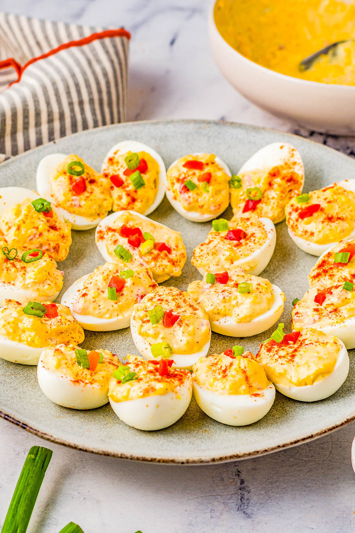 Pimento Cheese Deviled Eggs - A FAST and EASY recipe for the BEST deviled eggs because they're creamy, cheesy, and spiked with pimentos! Whether you're making them for a holiday party, game day or tailgating event, these are sure to be a crowd FAVORITE!