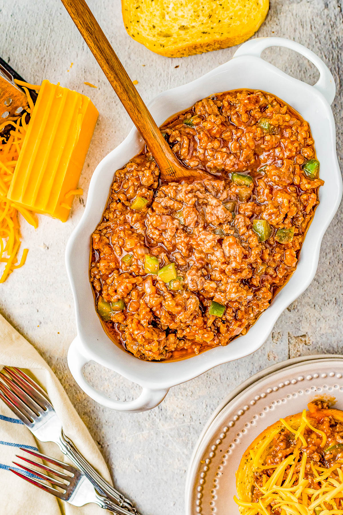 Slow Cooker Cheesy Sloppy Joes - Homemade sloppy Joes just got even better because they're cheesy! The perfect combination of sweet, tangy, optional spiciness, and so juicy! Whether you want to prep them before work for an easy weeknight dinner that's waiting, serve them at a summer holiday party, or for tailgating or a game day event, they're a classic family FAVORITE recipe and so EASY! Stovetop directions also provided.
