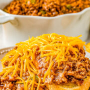 Cheesy slow cooker sloppy joe meat on a plate with bread.