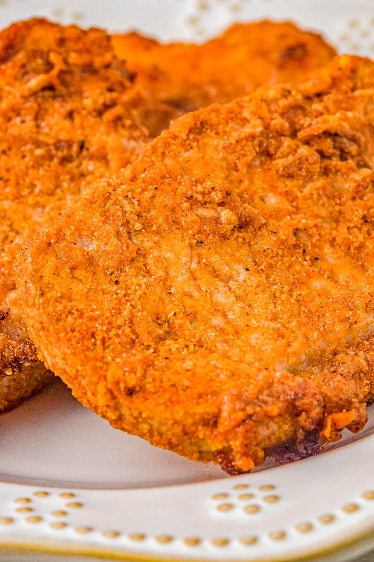 Air Fryer Pork Chops - Coated in Parmesan cheese and a rich spice rub, these air fried pork chops are perfectly crispy on the outside while staying tender and moist on the inside! They're EASY, ready in 15 minutes, perfect for busy weeknights, and a healthier way to enjoy "fried" food. Oven-baking and grilling instructions also provided.